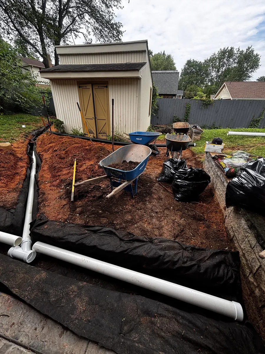Stormwater drainage trench with gravel and corrugated pipe